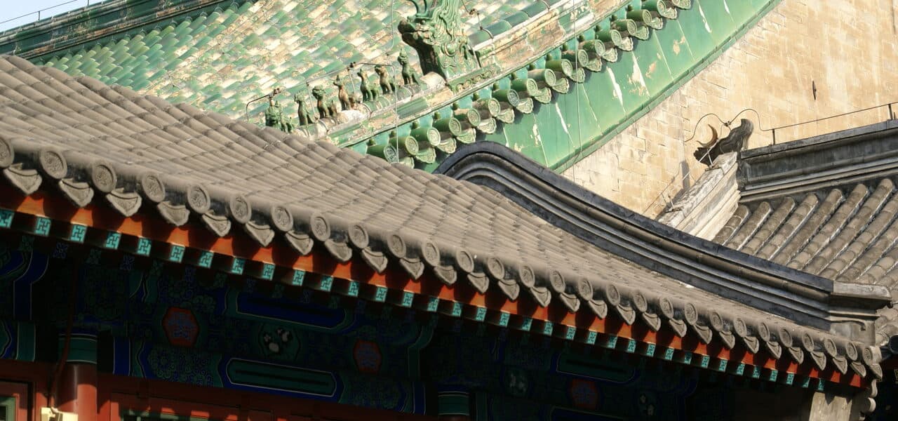 The Western Gate of Prince Gong's Mansion: a carved marble arch with its stone plaque below green glazed eaves