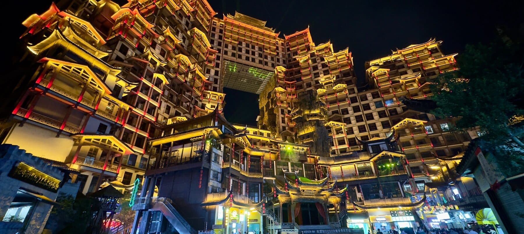 Tiered night towers glowing above the plaza