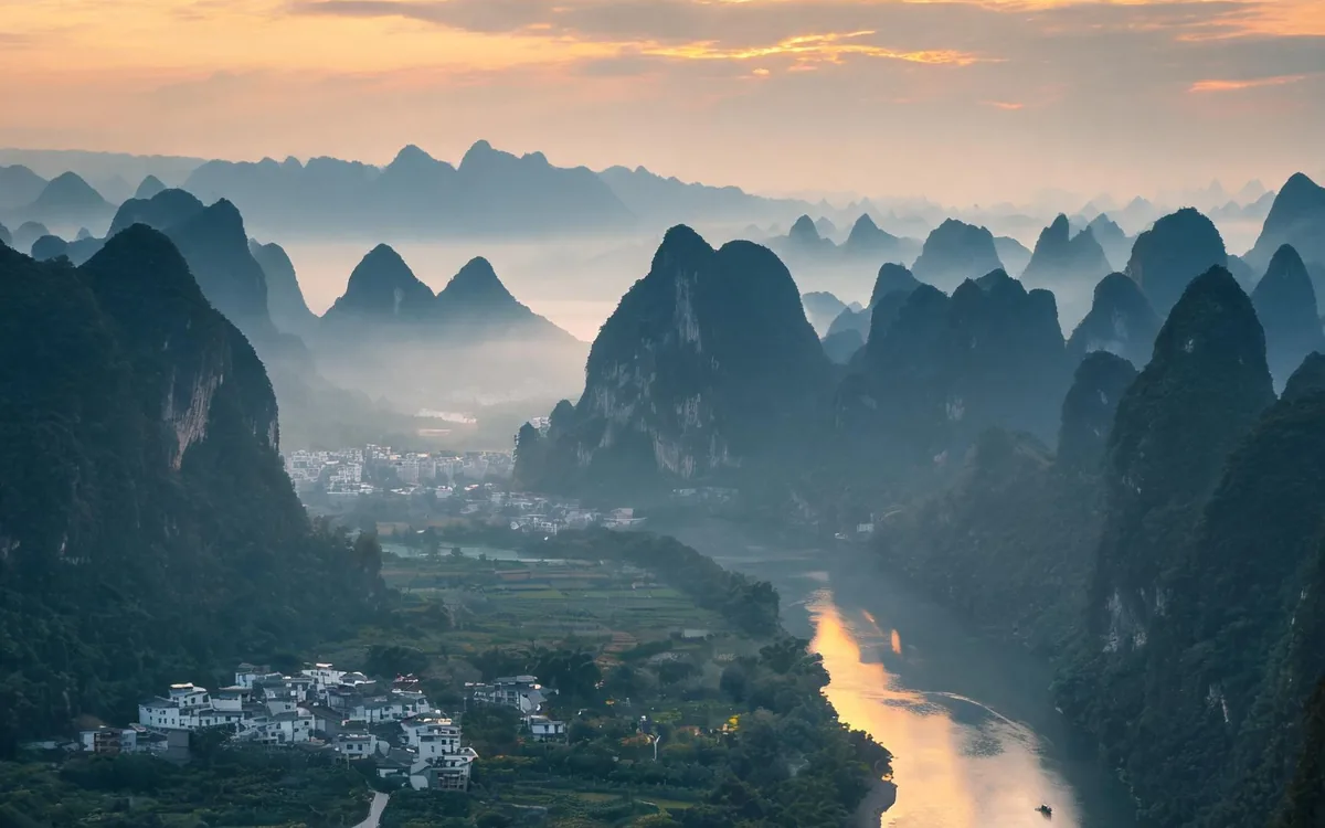 Karst peaks along a river at dawn near Guilin