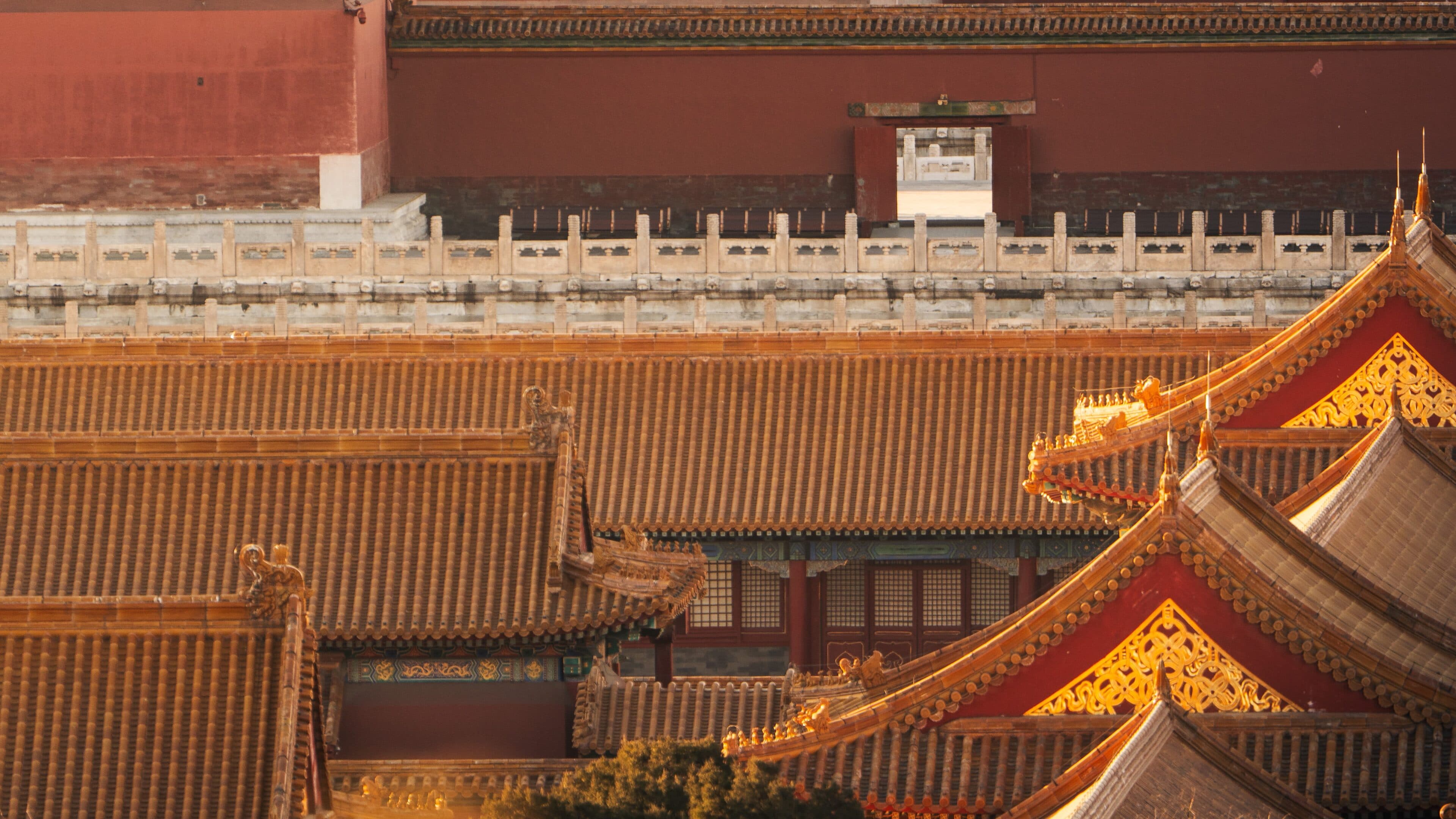 Sweeping yellow glazed-tile roofs, white marble balustrades, and dark red palace walls