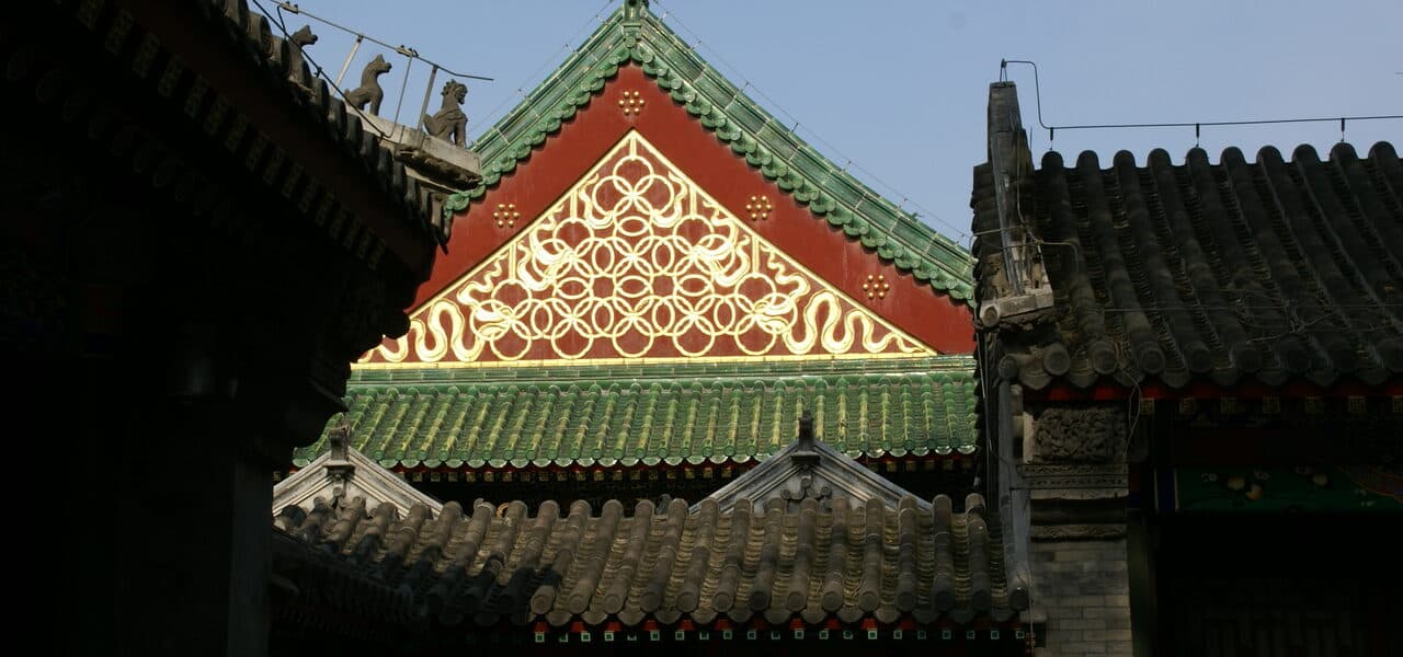 A hall in Prince Gong's Mansion: green glazed roof, vermilion beams and a carved gable