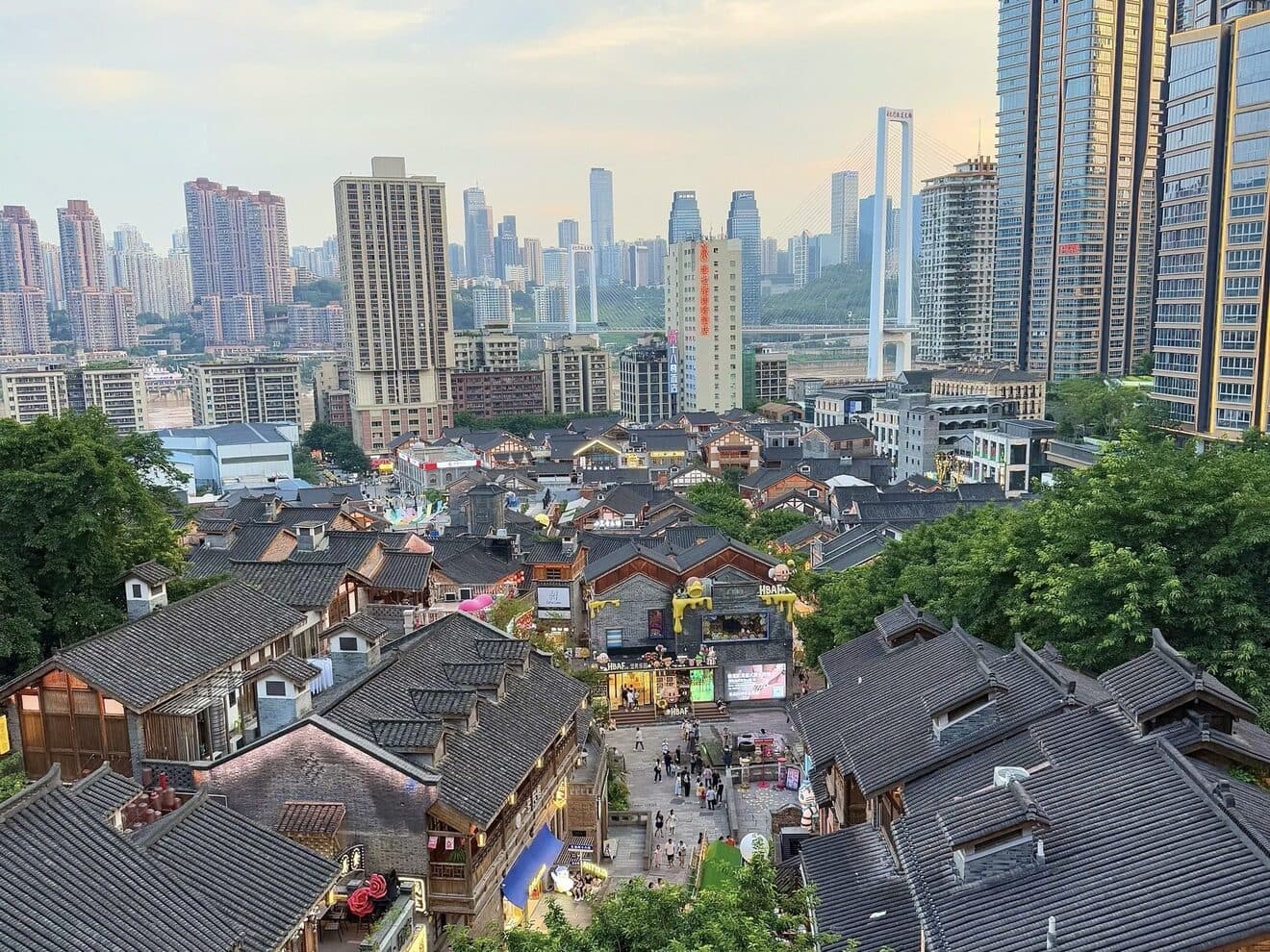 Layered grey-tile roofs of the old town below the modern skyline