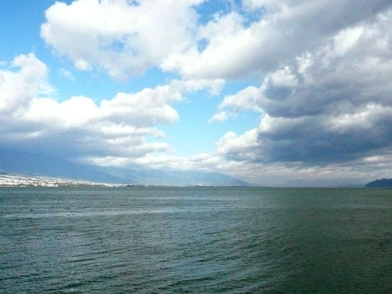 Erhai Lake at Dali: the water stretching to the foot of the far hills under a sky of white cloud