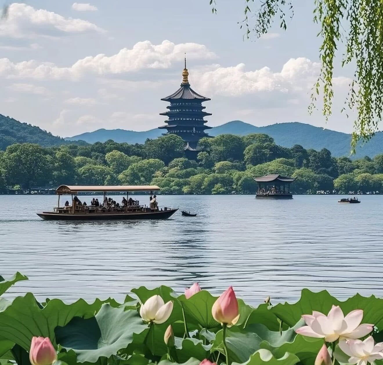 West Lake in Hangzhou by day: the water stretching toward Leifeng Pagoda, with lotus leaves and trees along the near bank