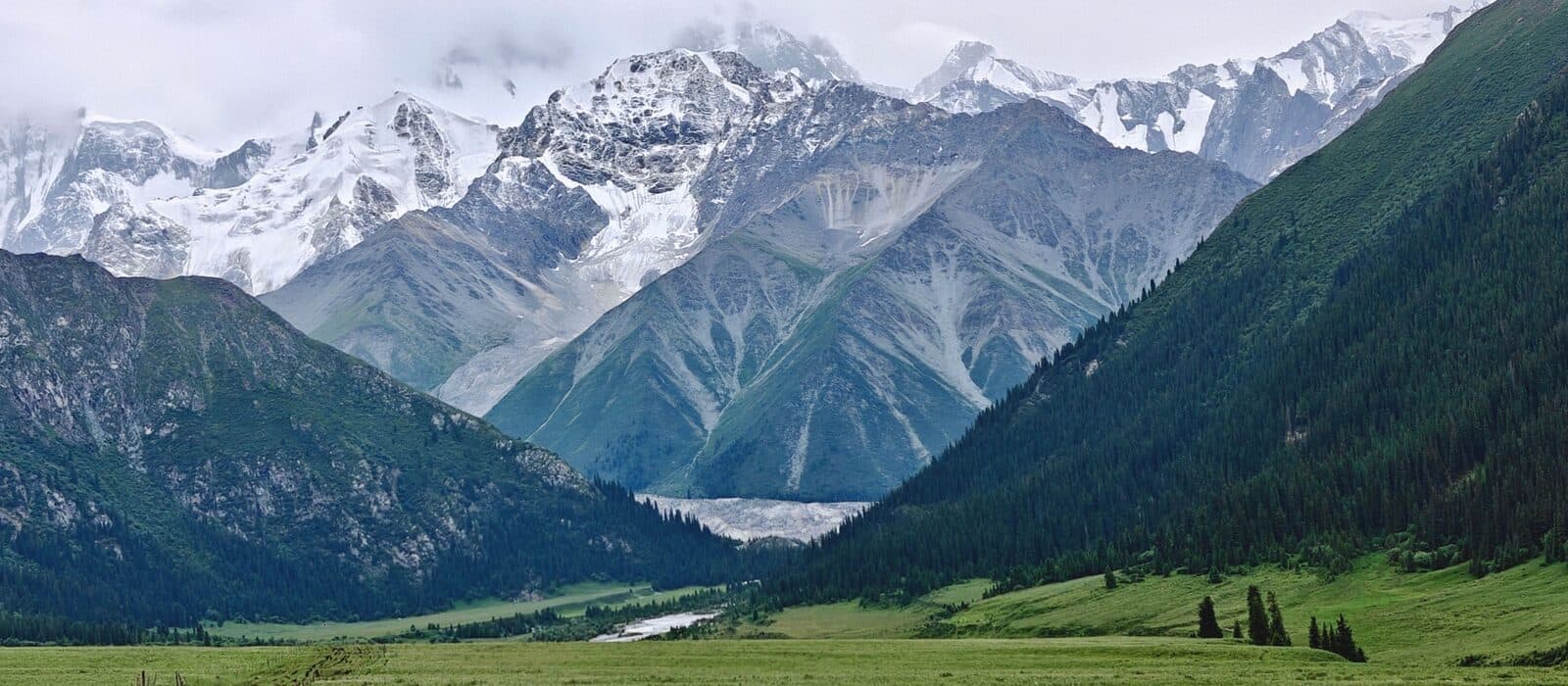 Snow-capped mountains in Ili under heavy cloud