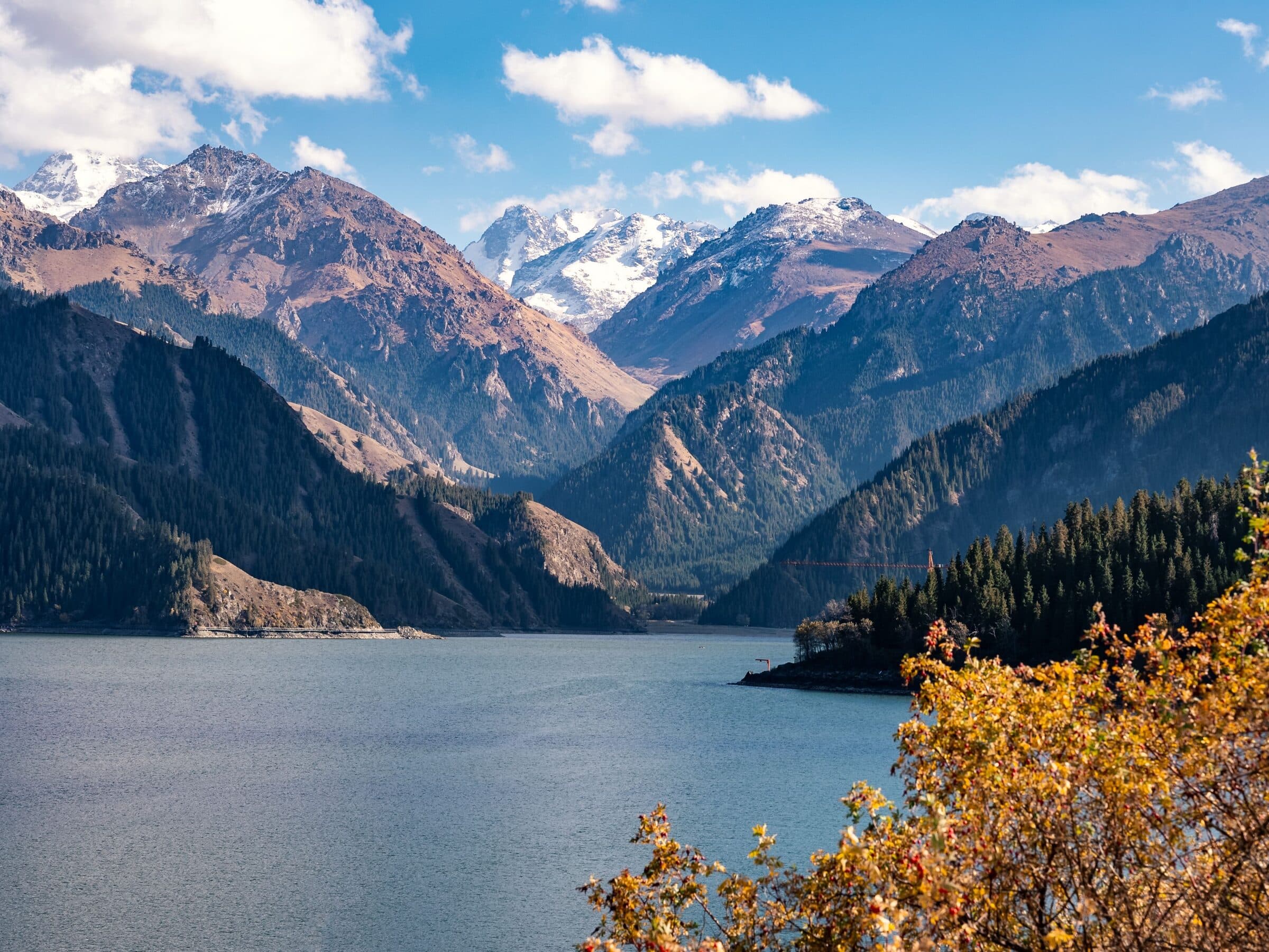 Tianchi below the Tianshan snow peaks, with autumn foliage in the foreground