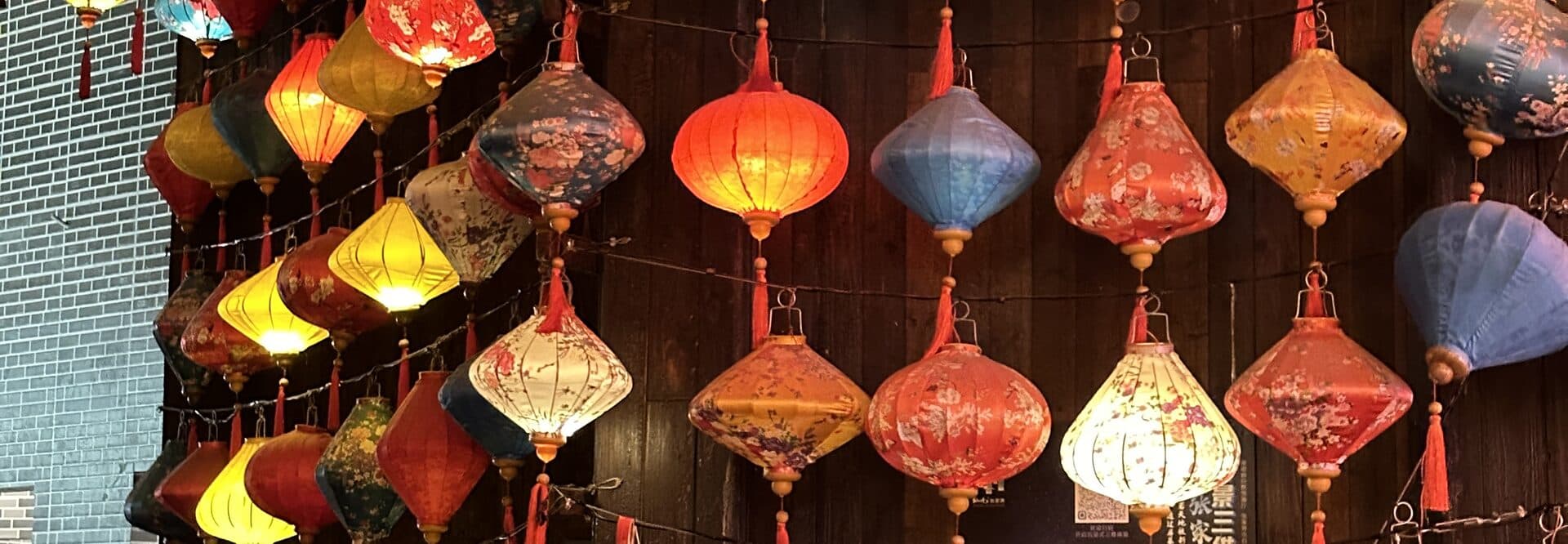 Painted lanterns hanging in rows on a night street