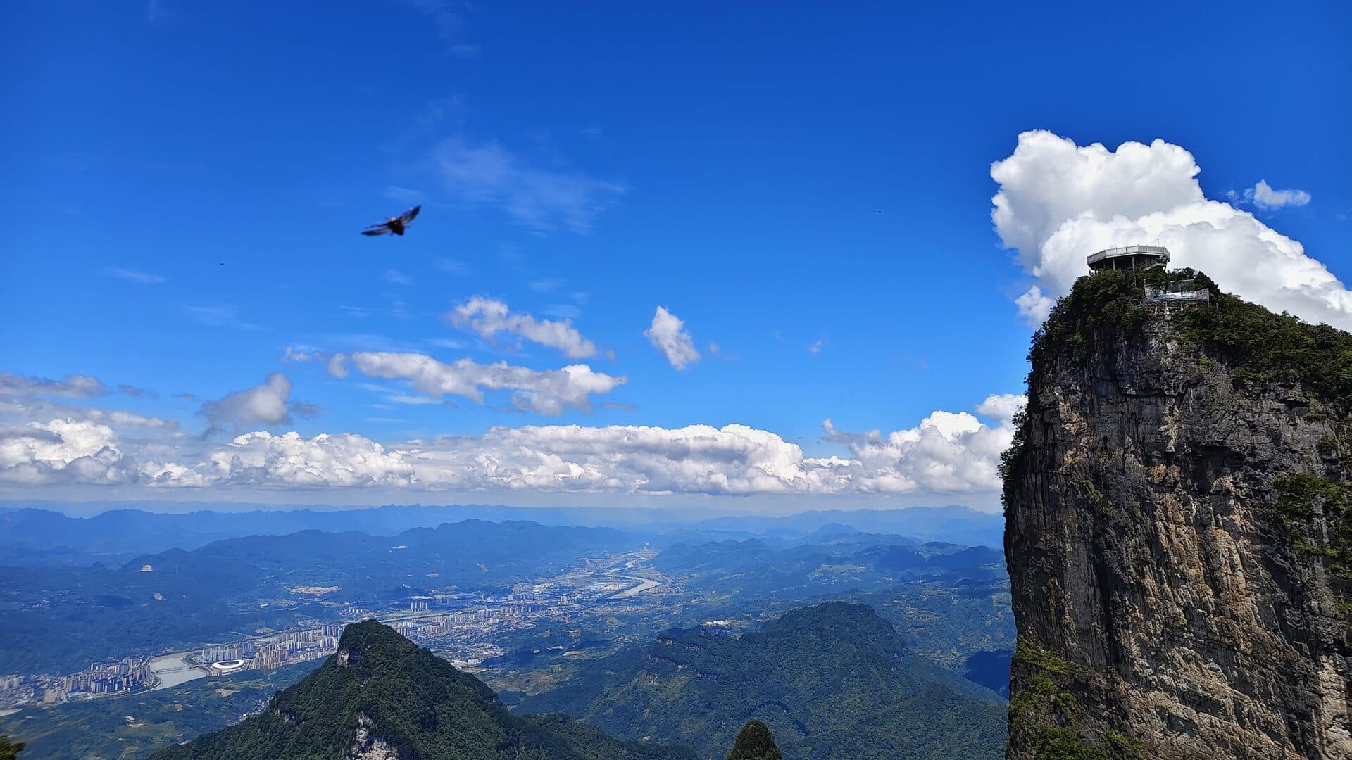 Daytime view over the Zhangjiajie city basin, its river and the karst peaks around it