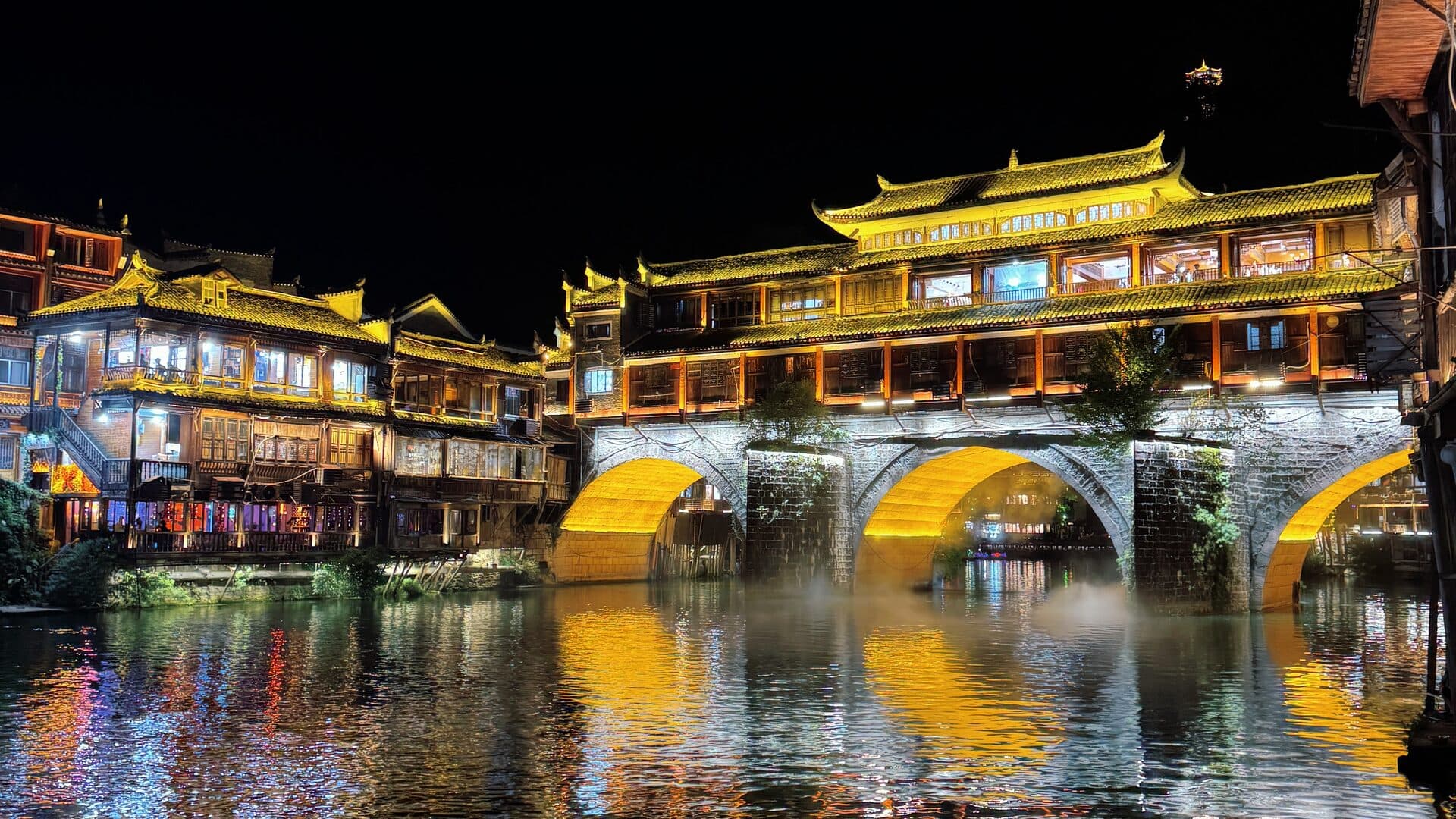 Fenghuang Ancient Town night lights reflected on the Tuojiang River