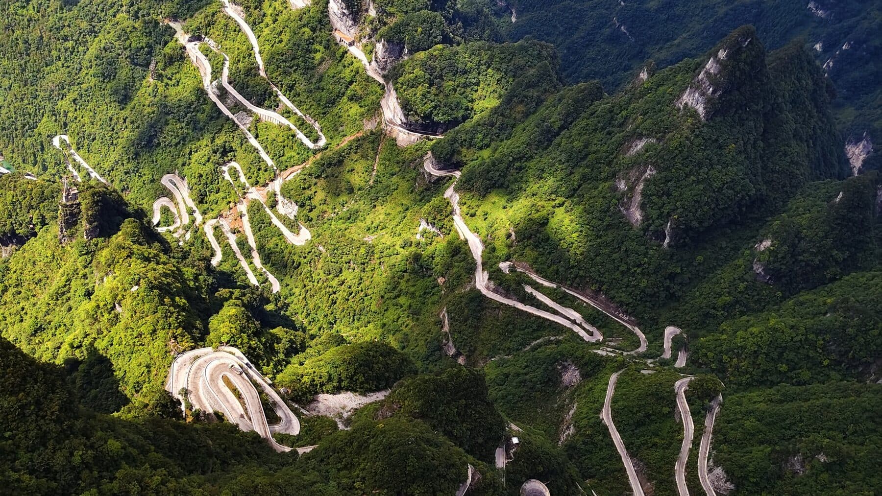Switchback mountain road winding through forested slopes