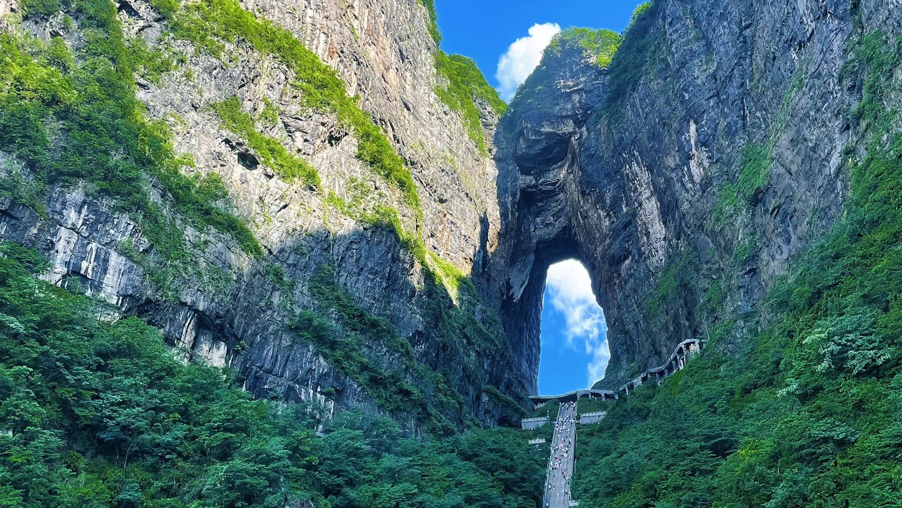 Tianmen Cave arch with the visitor stairway below on Tianmen Mountain