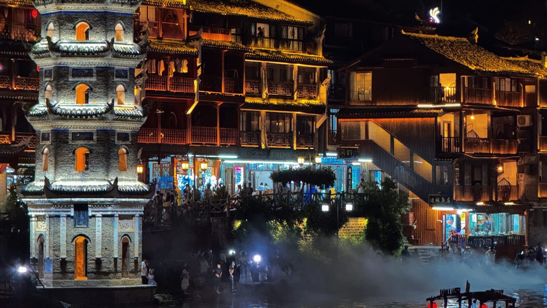 Western Hunan riverside old town lit at night along the river