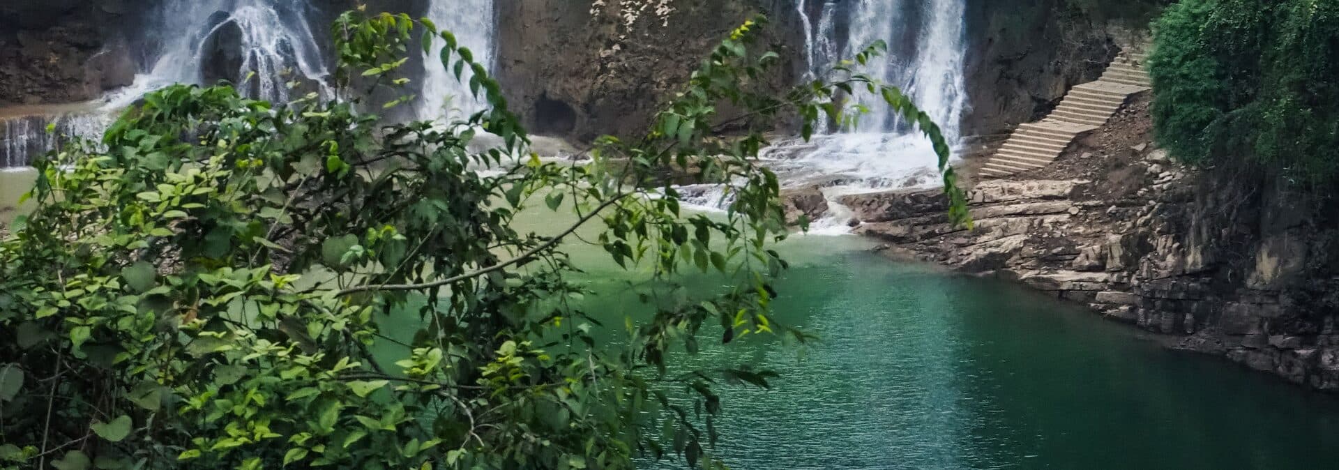 The tiered Furong Town waterfall and its emerald pool in western Hunan by day