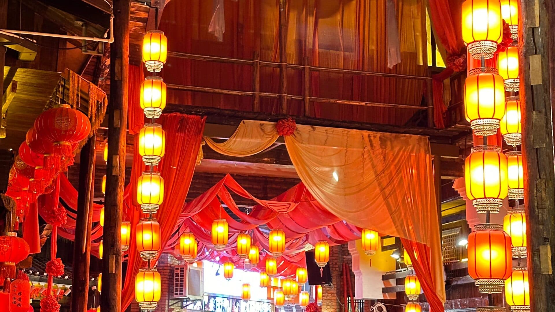 Lantern-decorated covered market lane in warm light