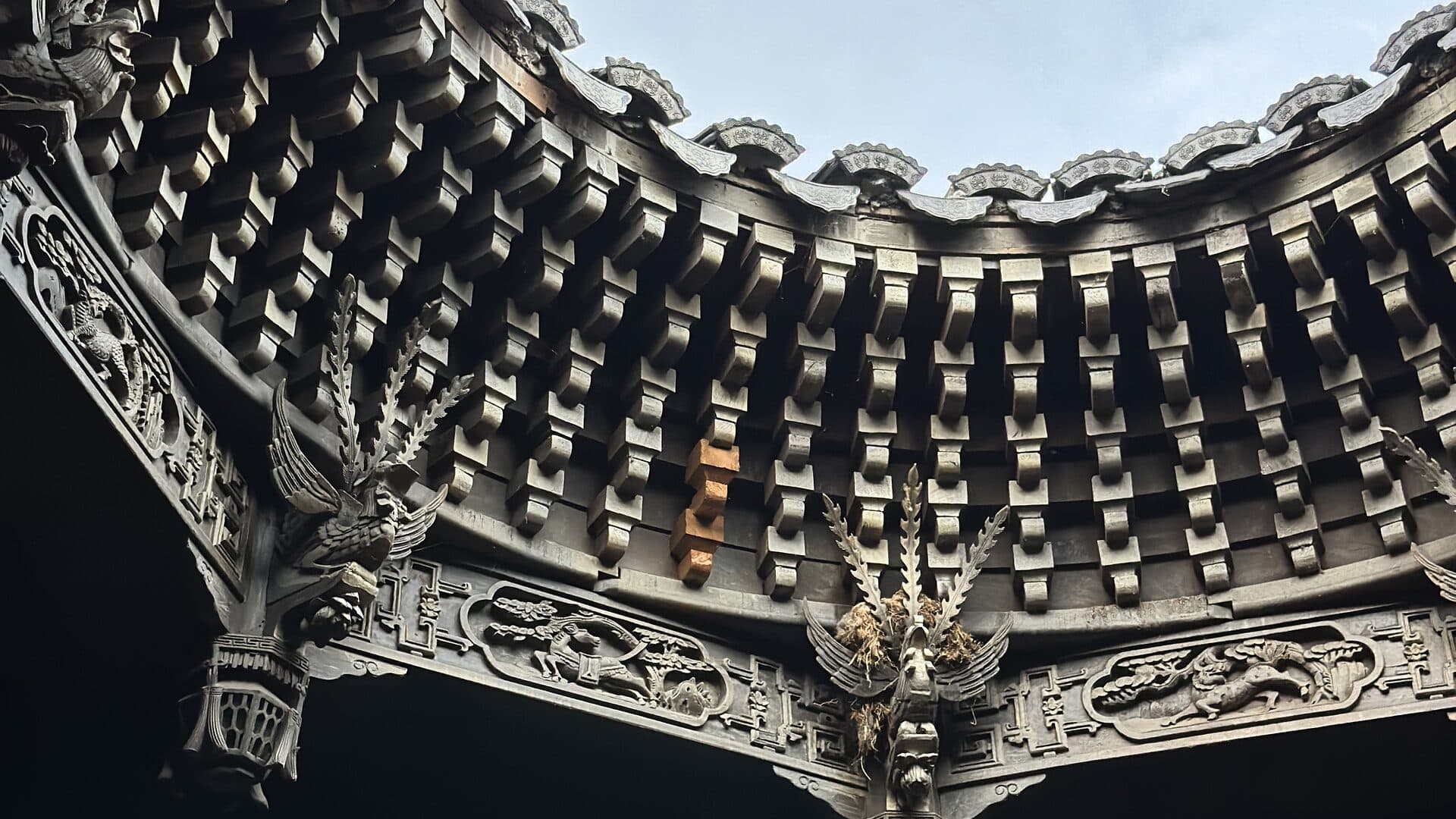 Carved brackets and tiled eaves of a traditional timber building