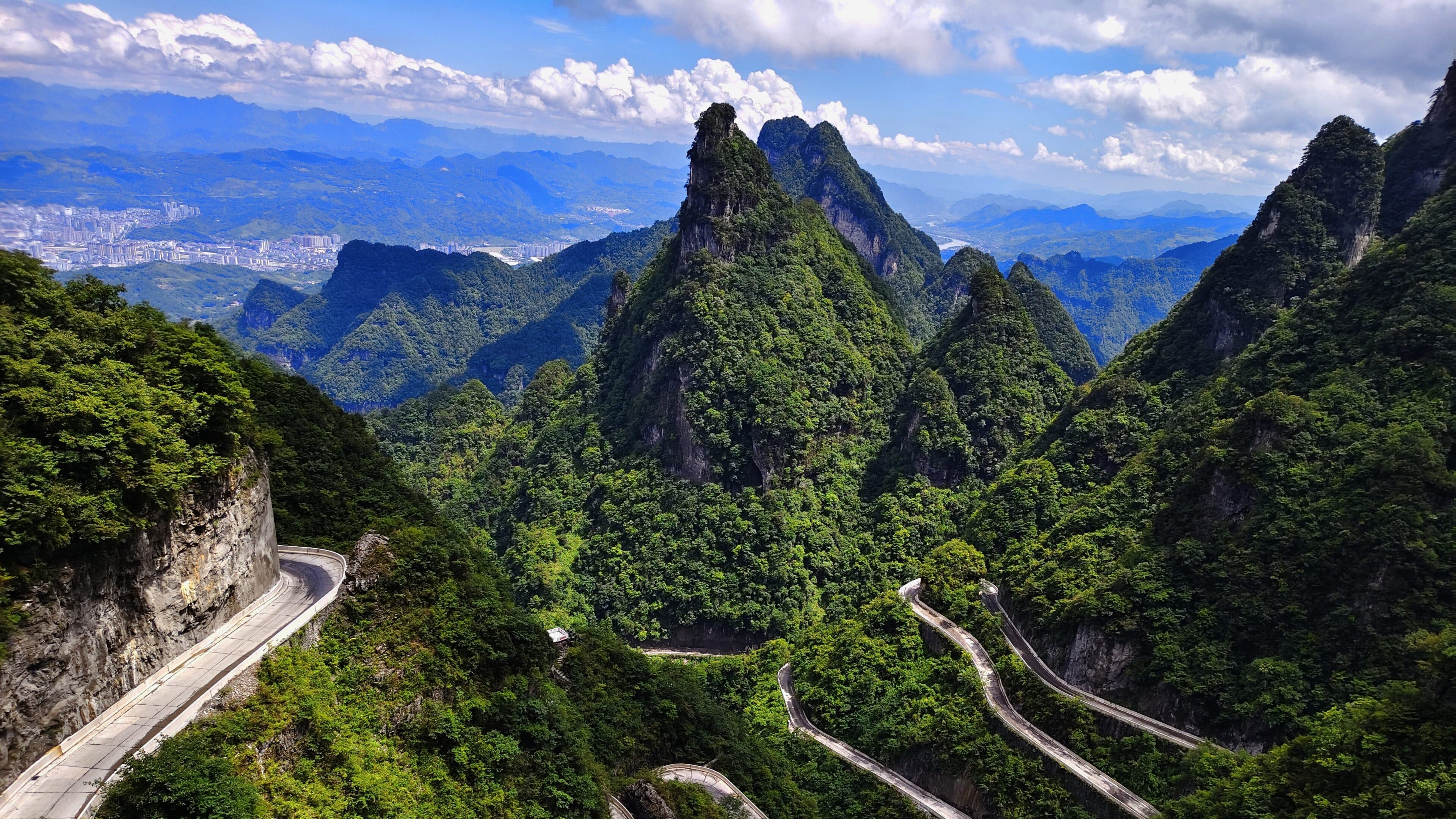 Karst peaks of Zhangjiajie with a winding mountain road above the valley