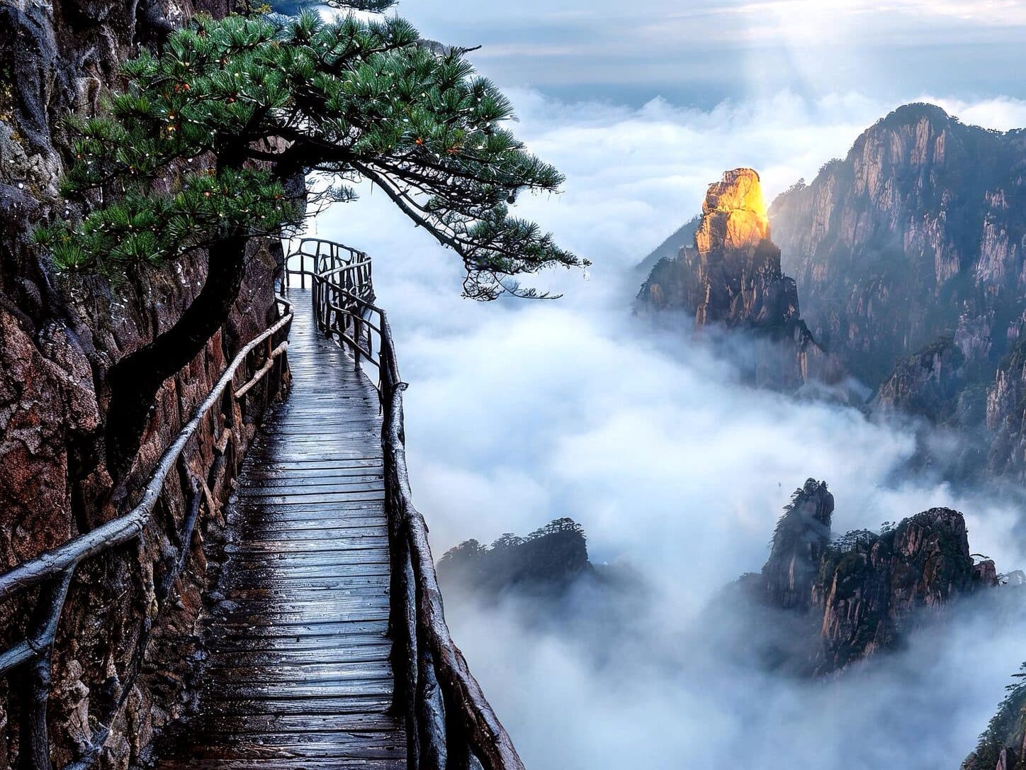 Stone steps climbing a cliff above a cloud sea