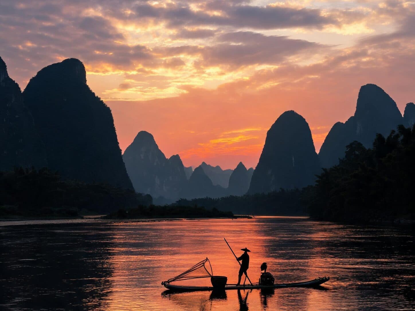 Karst peaks and a bamboo raft on the Li River at sunset